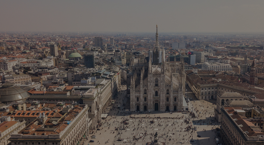 Aerial view of Milan Cathedral (Duomo di Milano) and Piazza del Duomo with crowds in front.