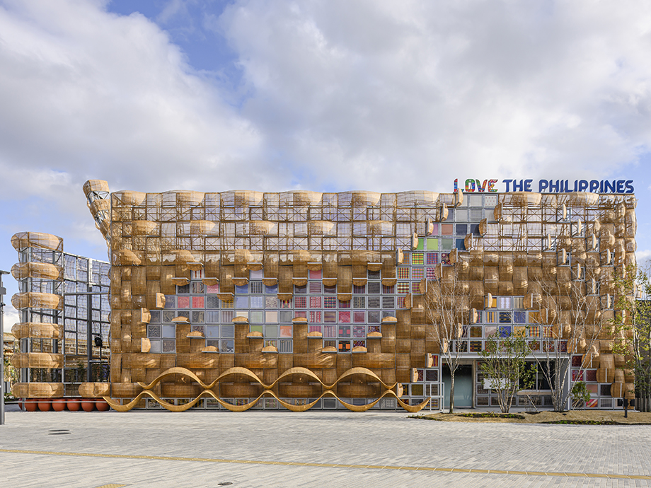 Facade covered in woven baskets forming a wave-like pattern, with a sign reading 'I LOVE THE PHILIPPINES' atop the building exterior.