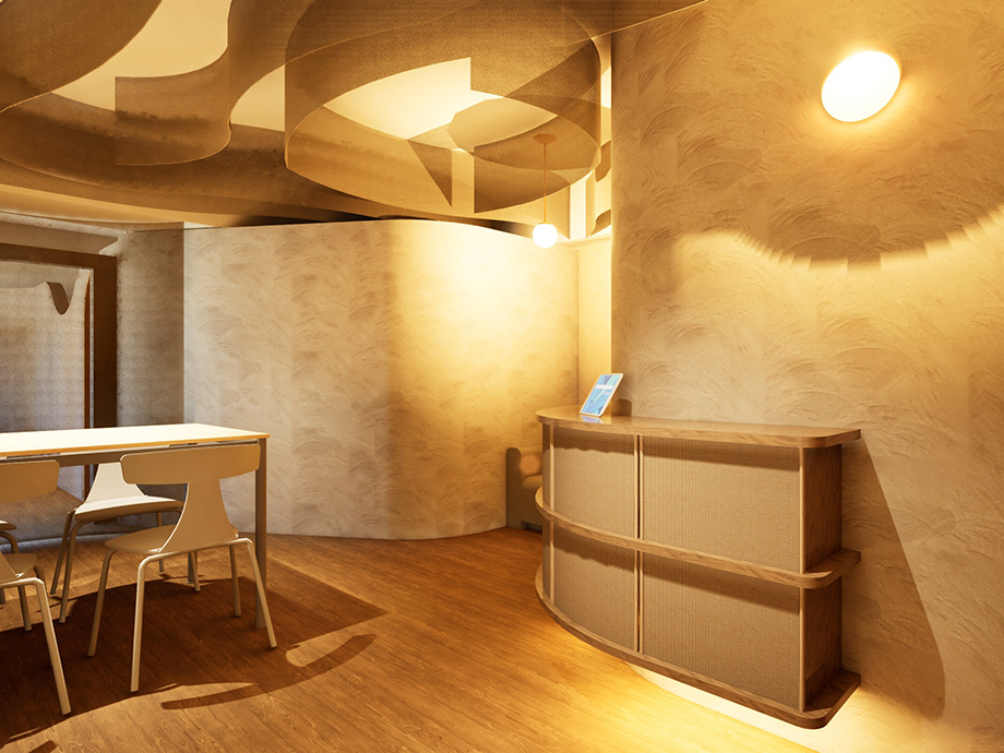 Modern reception area with a curved wooden desk, warm lighting, and white chairs around a rectangular table in a cream-toned room.