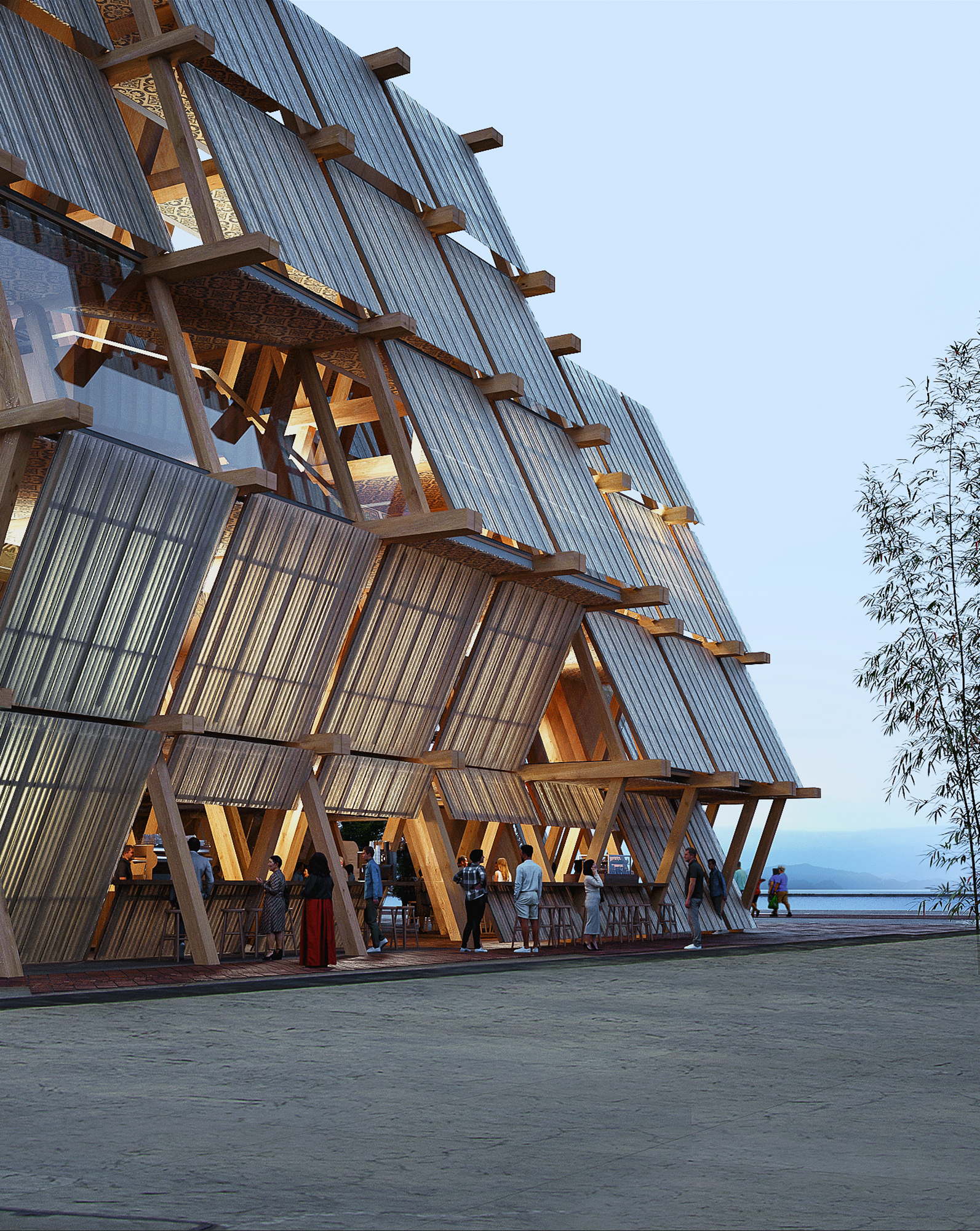 Open-air wooden and corrugated-metal pavilion along a waterfront, with people gathered at a covered terrace under a clear blue sky.